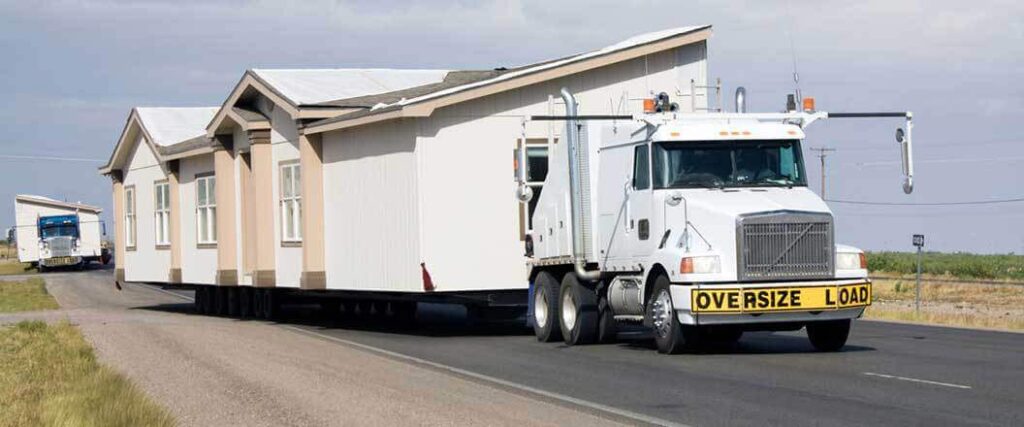 A semi truck transporting a mobile home 