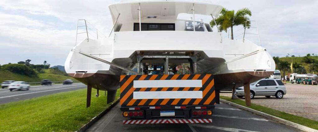 heavy haul freight brokers organize shipping of a catamaran by truck