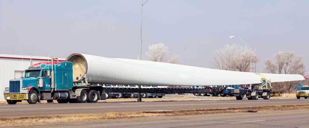 A semi truck transporting a  wind turbine