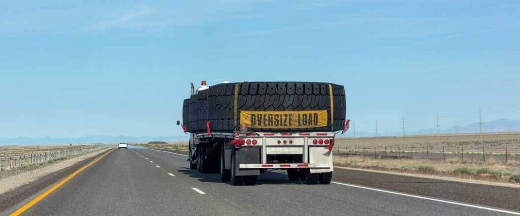 A semi truck transporting extremely large tires