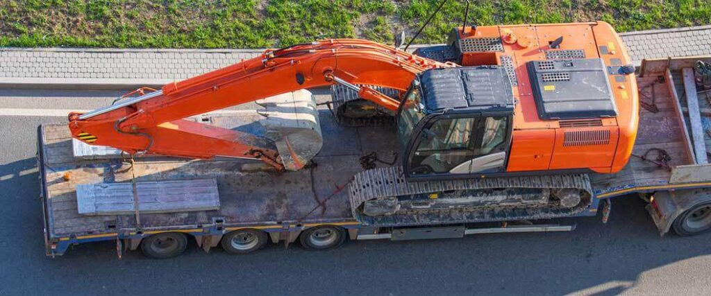 bird's-eye view of excavator secured to a flatbed trailer