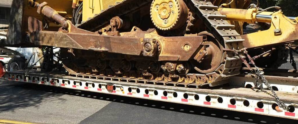 The treads of a bulldozer on a lowboy trailer