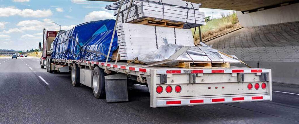 tarped and secured load on a flatbed trailer