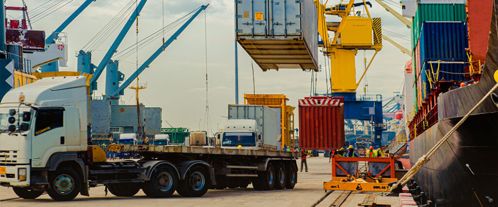 containers being loaded on a chassis