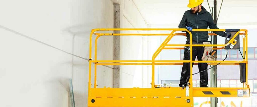 A worker that's learning how to transport a scissor lift