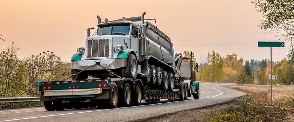 Lowboy trailer ideal for moving other large vehicles such as this dump truck. 